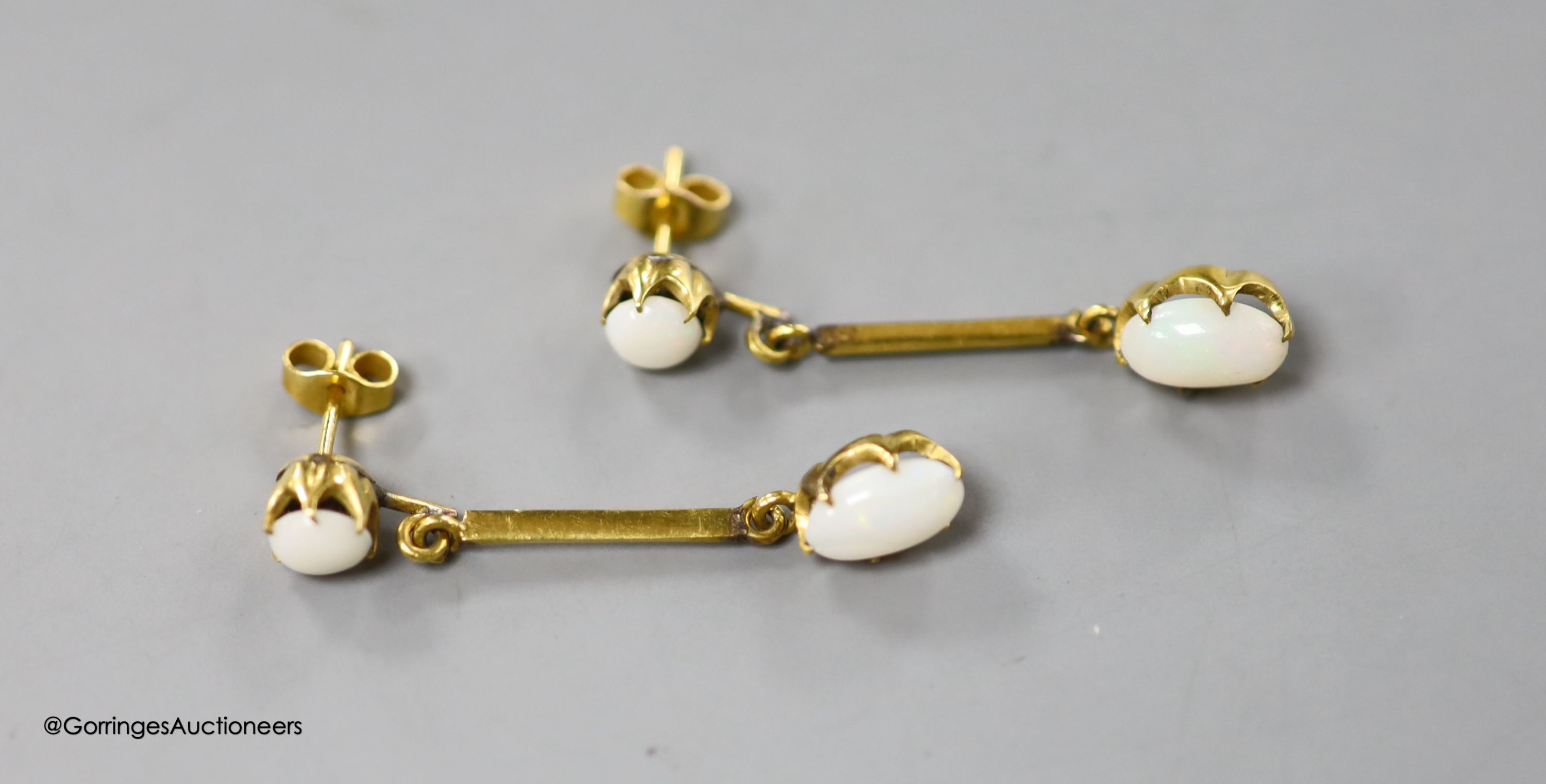 A pair of 9ct and two stone white opal set drop earrings, 36mm, gross 2.9 grams (one of the appears to be a replaced simulated opal which is also chipped).